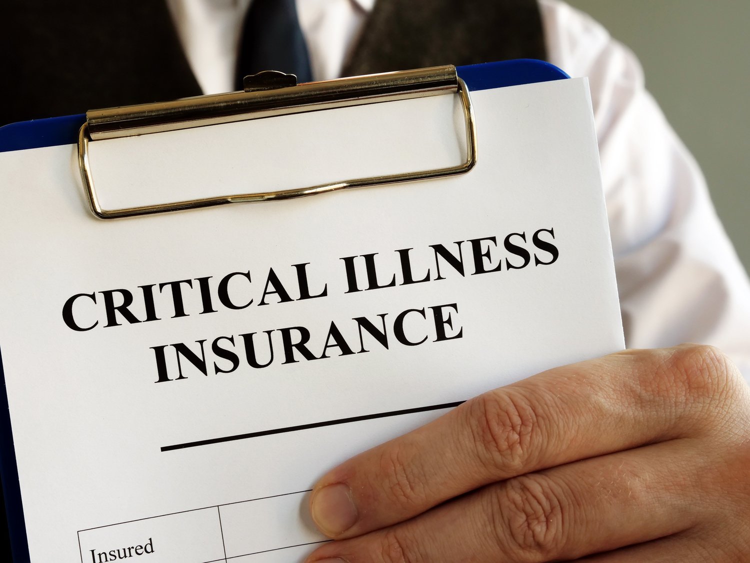 Critical illness insurance application form in the hands.